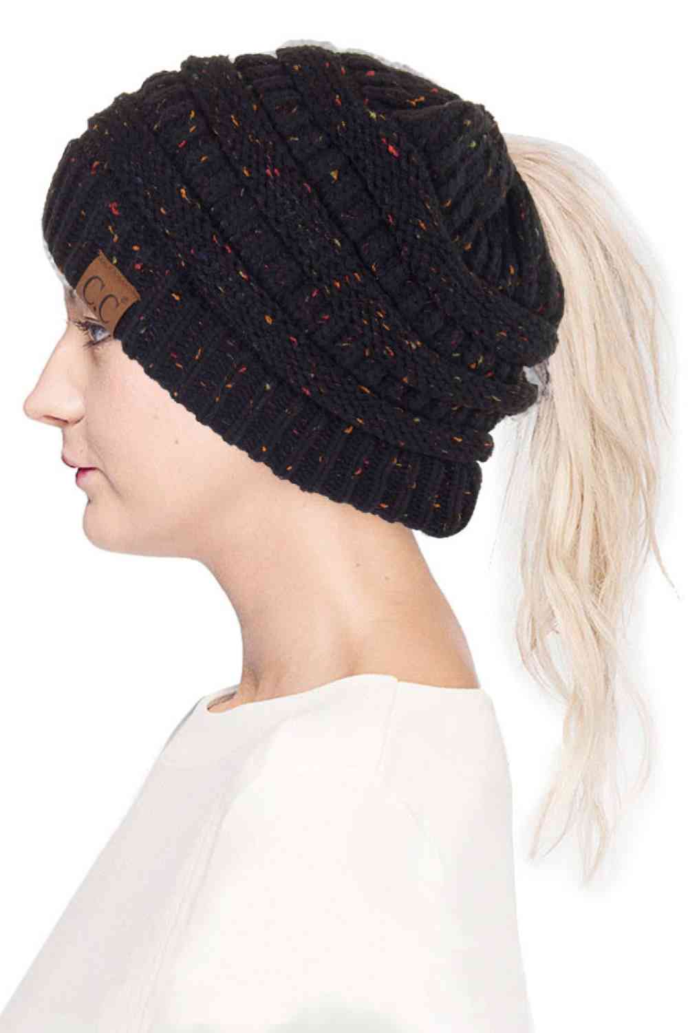 Black The C.C Confetti Ponytail Messy Bun Beanie features a soft knit design with subtle confetti flecks for a fun, playful look. Designed with a convenient opening for ponytails or messy buns, it keeps you warm while allowing you to style your hair comfortably.