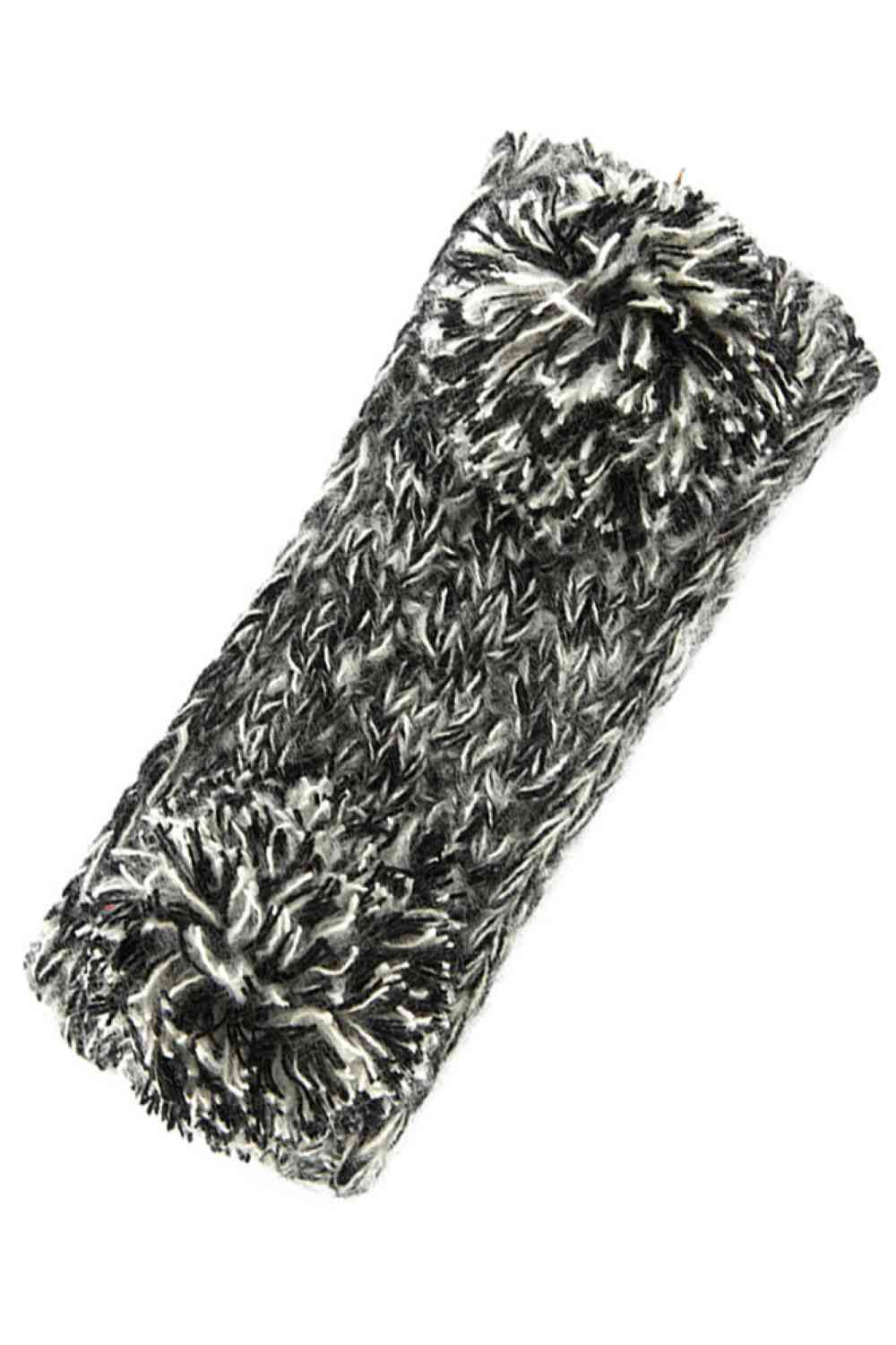 Black Cozy two-tone kids head wrap featuring a soft fuzzy lining for extra warmth and comfort. Double pom-pom design adds playful style perfect for cold weather. Crafted from 100% acrylic for durability and easy care. One size fits most children. A practical accessory that keeps little ones warm while looking adorable.