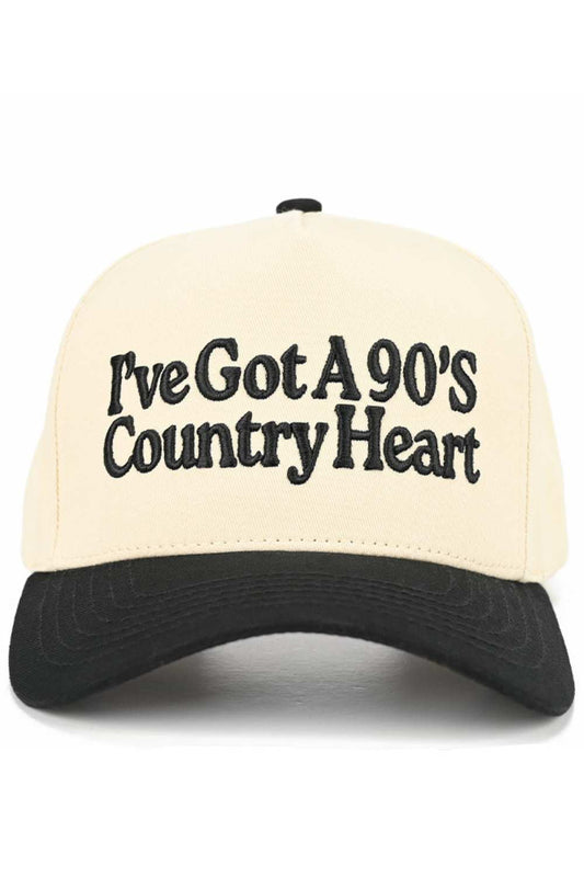 Black Embrace your country spirit with this charming C.C trucker hat featuring an embroidered "I'VE GOT A 90'S COUNTRY HEART" design. Crafted from 100% cotton, this two-tone baseball cap delivers comfort and style for everyday wear. The adjustable snap back closure ensures a perfect fit for most head sizes, with a 22.5" circumference. Whether you're a country music fan or love vintage-inspired fashion, this hat adds authentic flair to any outfit. Made in Vietnam with quality construction that lasts.