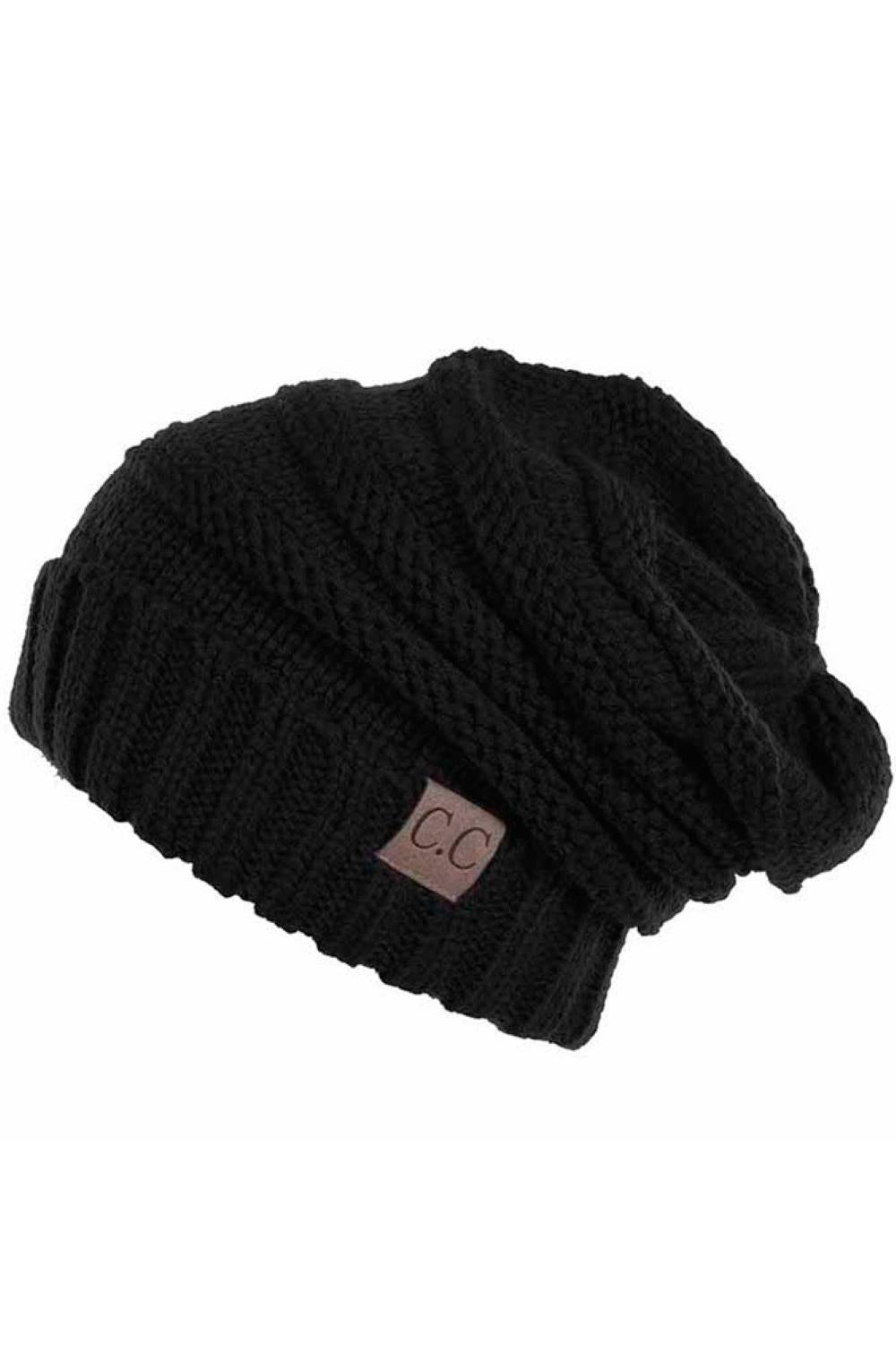 Black Wrap yourself in warmth with this C.C Slouchy Knitted Beanie, crafted from 100% soft acrylic for ultimate comfort. The oversized silhouette and plush pom pom detail create a relaxed, on-trend look perfect for chilly days. Available in nine versatile colors—Beige, Berry, Dark Denim, Heather Gray, Ivory, Pistachio, Rose, Steel Blue, and Violet Purple—this beanie pairs effortlessly with any winter wardrobe. The ribbed knit construction ensures durability and a flattering fit. Hand wash and lay flat to dr