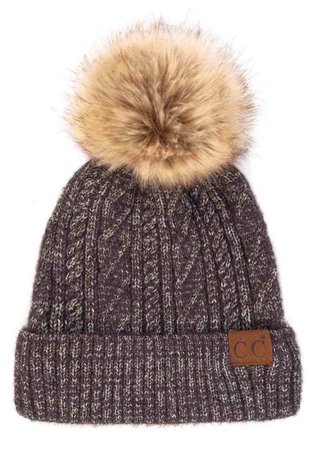 Black The C.C Soft Cuff Beanie in Mixed Cable Pattern with Faux Fur Pom features a stylish blend of cable-knit textures topped with a plush faux fur pom for a chic winter look. Made from soft, stretchy fabric with a cozy cuff, it provides warmth, comfort, and a snug fit for cold-weather wear.