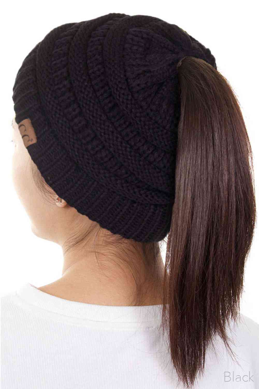 Black The C.C Solid Color Ponytail Messy Bun Beanie combines comfort with versatility for effortless everyday style. Crafted from 100% soft acrylic, this beanie features an open crown design that accommodates ponytails and messy buns while keeping you warm. The one-size-fits-most construction ensures a secure, flattering fit for virtually anyone. Perfect for casual outings, workouts, or relaxed weekends, this practical accessory transitions seamlessly from season to season.