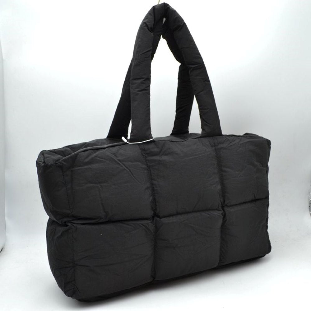 Black Meet your new go-to everyday companion with this Chic Quilted Puffer Tote Bag. This oversized puffer tote perfectly blends streetwear style with practical, lightweight functionality, making it ideal for travel, work, gym gear, or daily errands.