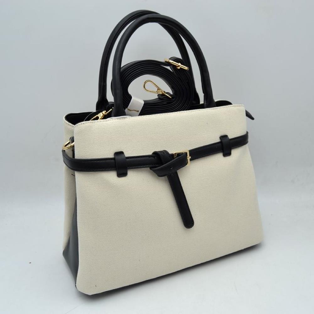 Black Elevate your daily wardrobe with this sophisticated belted satchel. Combining the relaxed texture of a woven canvas body with the structure of sleek faux-leather trim, this handbag brings a tailored, high-end feel to any look. Perfect for professional environments, travel, or upscale weekend outings, its clean silhouette and distinctive knotted belt accent make it a timeless choice for the modern wardrobe.