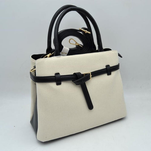 Black Elevate your daily wardrobe with this sophisticated belted satchel. Combining the relaxed texture of a woven canvas body with the structure of sleek faux-leather trim, this handbag brings a tailored, high-end feel to any look. Perfect for professional environments, travel, or upscale weekend outings, its clean silhouette and distinctive knotted belt accent make it a timeless choice for the modern wardrobe.