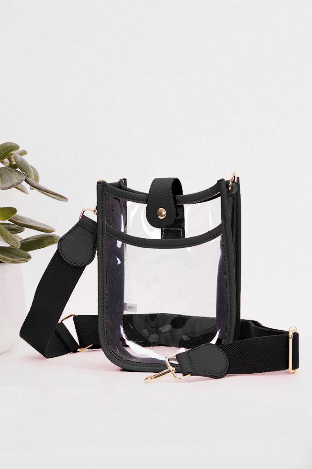 Black Perfect for concert season and stadium events, this clear crossbody mini bag meets all venue security requirements while keeping your essentials within reach. Crafted from durable 100% PVC, it's easy to clean and built to last through countless outings. Compact yet functional at 8" x 5.8" x 2.3", the adjustable crossbody strap sits comfortably across your body, leaving your hands free. The transparent design lets you quickly locate your phone, keys, and small valuables at a glance.