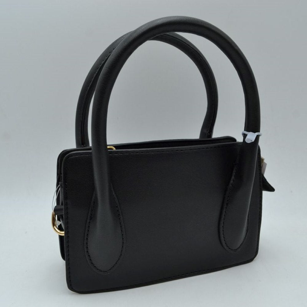 Black This classic handbag features a structured rectangular silhouette with a smooth finish and clean stitched detailing, making it ideal for sophisticated everyday use. Designed with an open-top layout, it includes multiple divided storage compartments to keep your daily essentials organized and within reach. Dual arched top handles provide a comfortable grip for handheld carrying, while subtle metallic side rings offer a discreet attachment point for versatile styling options.