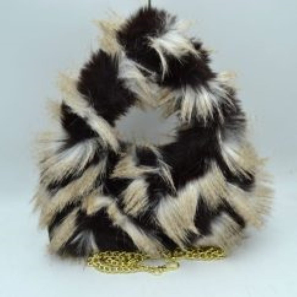Black This distinctive everyday handbag showcases a statement-making, long-pile shaggy plush exterior that adds unique dimension and tactile texture to your accessory collection. Designed with a soft, rounded triangular silhouette, it features a built-in top cutout handle for convenient hand carrying, alongside a separate metallic chain strap for versatile alternative styling. The central top opening provides straightforward access to the main storage compartment