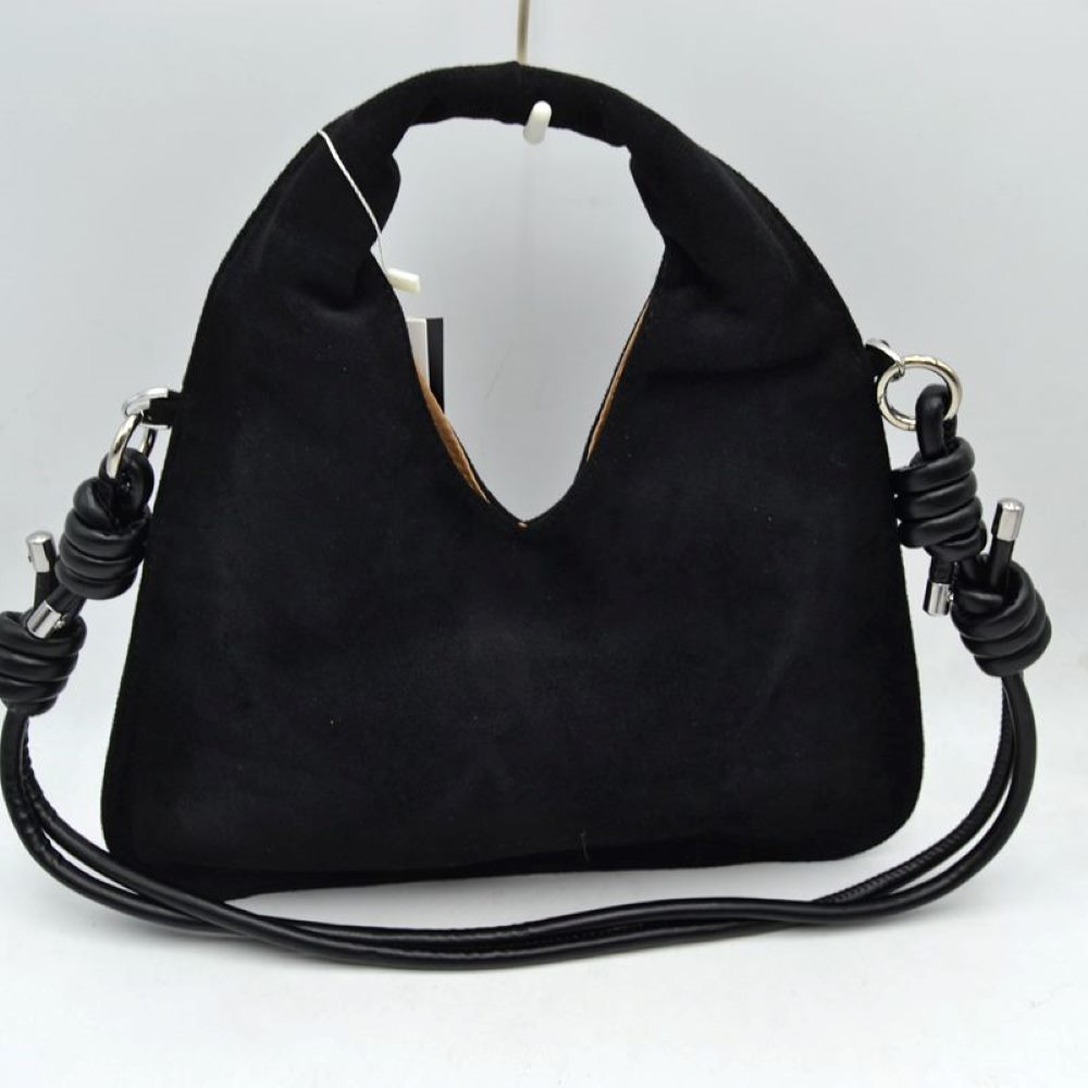 Black This slouchy hobo bag features a soft, matte suede-textured exterior with a modern silhouette, making it a stylish choice for everyday use. It is designed with a deep V-shaped cutout that transitions seamlessly into a comfortable, integrated top handle for an easy handheld carry. The look is elevated by a slender, matching shoulder strap attached to silver-tone side rings