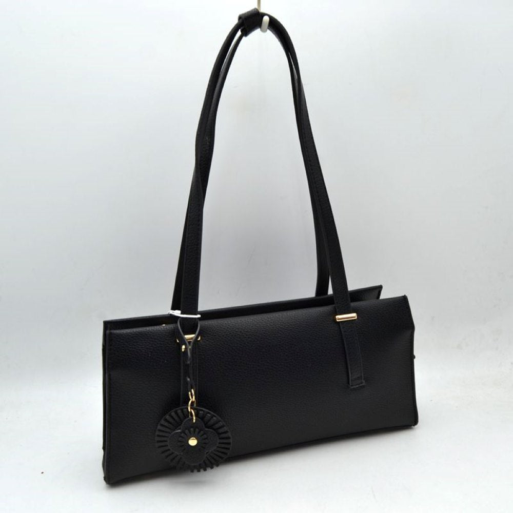 Black Upgrade your everyday style with this sleek and sophisticated black shoulder tote bag. Designed with a modern rectangular silhouette, this handbag combines elegance and practicality for daily use. Crafted from textured faux leather, it features comfortable shoulder straps, a spacious interior, and a stylish decorative charm for a fashionable finishing touch. Perfect for work, shopping, casual outings, or evening occasions, this versatile bag complements both formal and casual wardrobes.