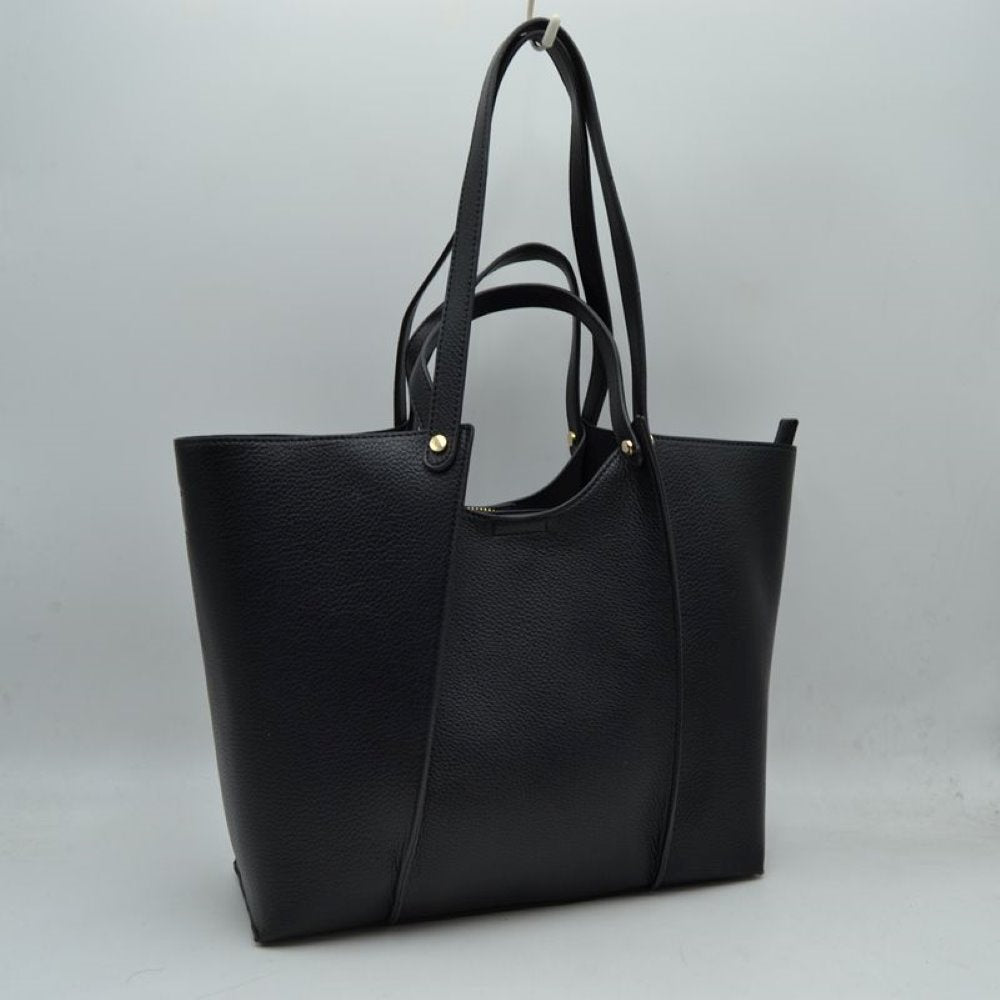 Black This versatile tote bag is a sophisticated addition to any collection. Crafted from high-quality, durable material, it combines a structured, minimalist shape with a rich, tactile finish. Designed for the modern professional or frequent traveler, it features an elegant central panel design and is adorned with polished gold hardware studs that add a touch of understated luxury.