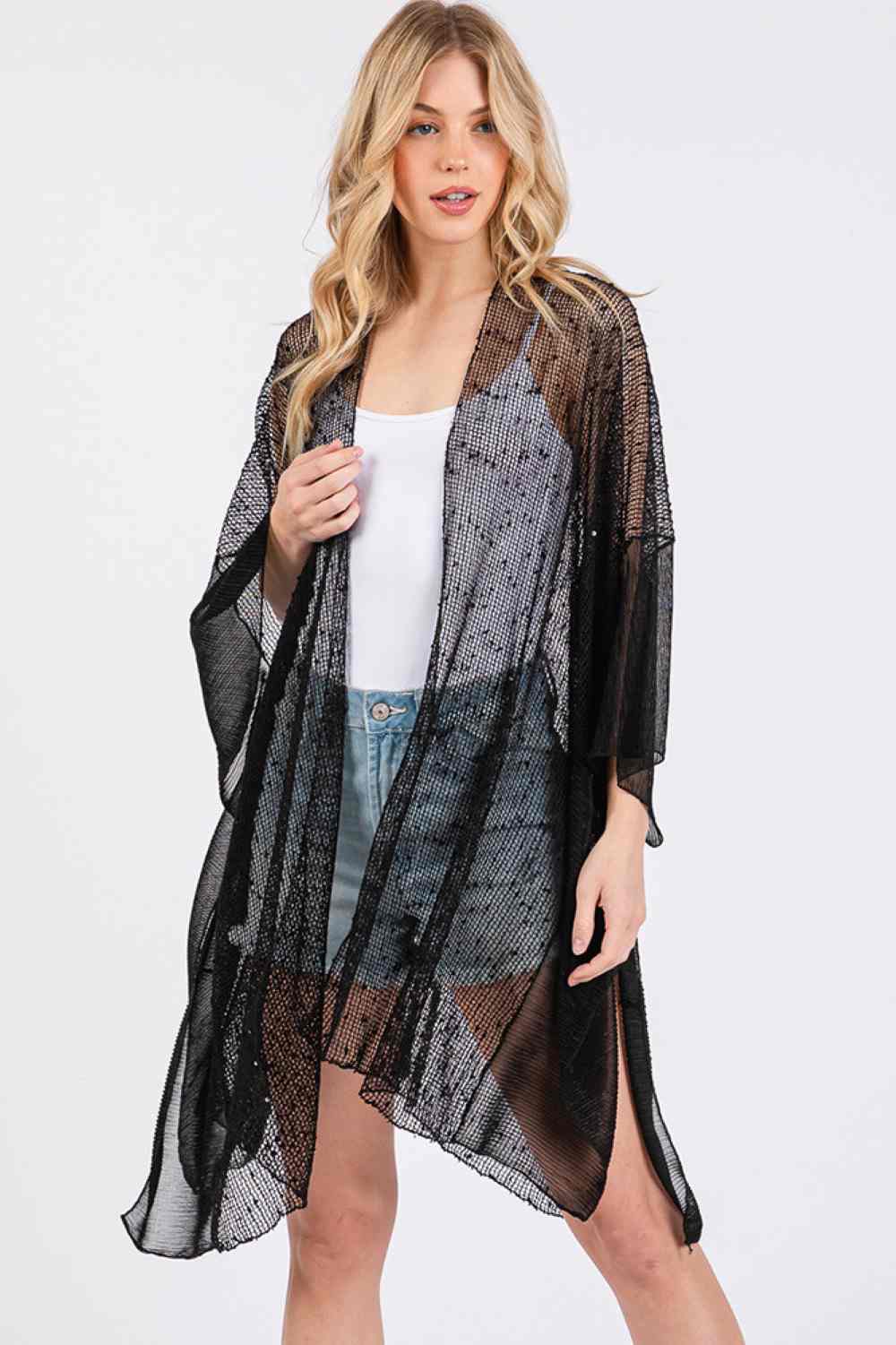 Black Elevate your beach look with this shimmering sequin mesh cover up. Crafted from lightweight polyester, it drapes beautifully over your swimwear while catching the light with every movement. The solid mesh design offers a sophisticated, see-through aesthetic perfect for poolside strolls or beachside moments. Measuring 41" x 31", it provides comfortable coverage without bulk. An effortless way to transition from water to shore in style.