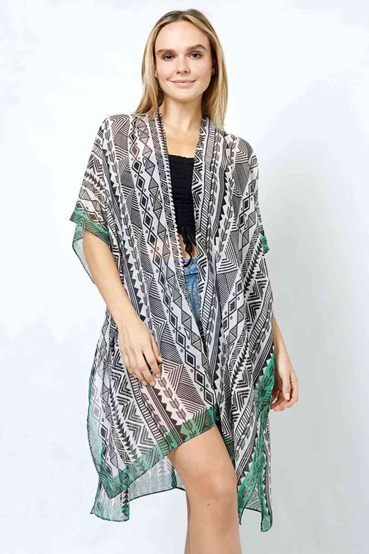 Black Embrace effortless elegance with this Ethnic Pattern Print Kimono. Featuring a striking ethnic-inspired design, this lightweight piece drapes beautifully over any outfit for an instant style upgrade. Crafted from 100% polyester for easy care and durability, it offers comfortable wear throughout the day. With a generous 35" length, it provides excellent coverage and movement.