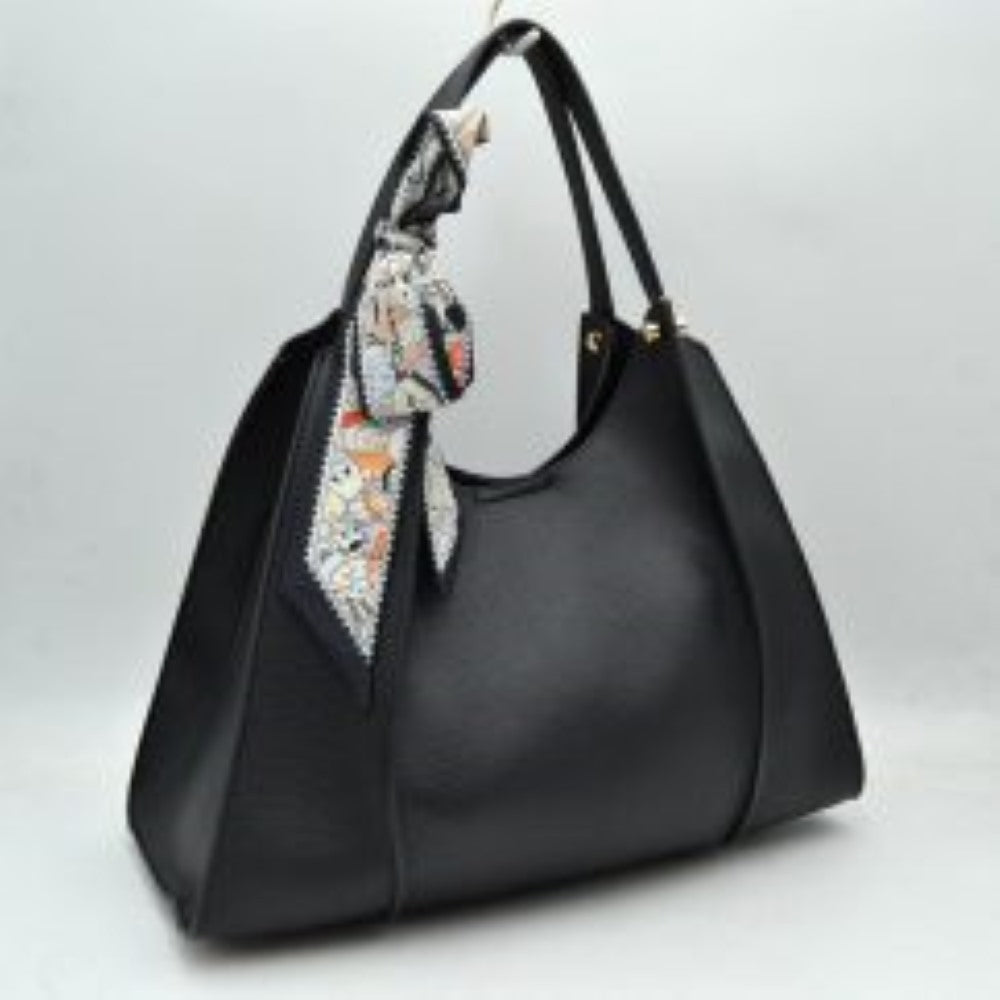 Black Step out in effortless elegance with this beautifully structured shoulder tote bag, designed for the modern individual who values both style and functionality. Featuring a refined pebble-textured finish and a clean, sculptural silhouette, this handbag offers a sophisticated look that seamlessly transitions from office boardrooms to weekend outings. The bag is chicly accessorized with a removable black-and-white floral print scarf tied around the strap, adding a graceful, artistic flair.