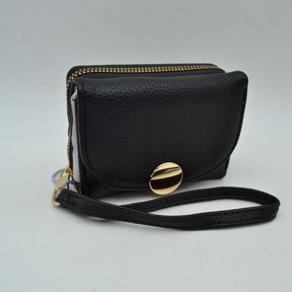 Blac This compact everyday wallet features a pebbled, textured exterior designed for practical multi-compartment storage. It includes a secure, top zip-around section with metallic teeth alongside a front fold-over flap portion accented by a prominent round metallic button closure. For convenient carrying during daily errands, it comes equipped with a slim, matching wristlet strap attached to the side hardware.