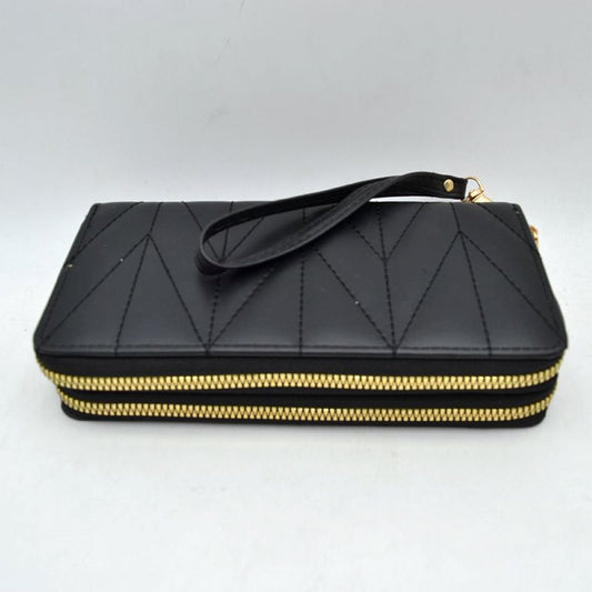Black This rectangular long wallet features a distinctive geometric stitched pattern across its exterior, providing a refined and structured look for everyday use. Designed to offer organized storage compartments, it incorporates a dual zip-around closure system with prominent metallic zippers to keep essentials secure. A matching, detachable flat wristlet strap is connected to the side hardware with a metallic clasp, providing an easy and convenient hands-free carrying style.