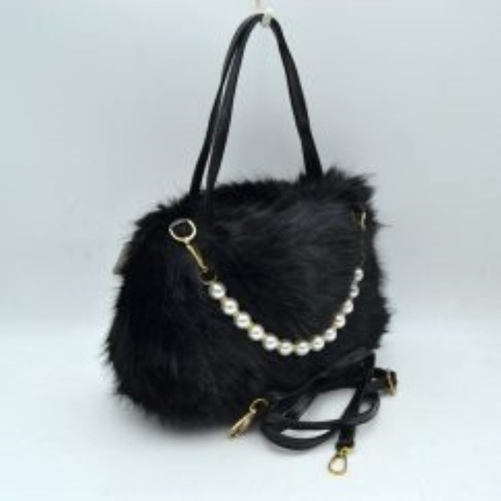 Black This unique everyday handbag showcases a soft, textured plush exterior that introduces a cozy aesthetic to your accessory collection. The bag features an expansive central storage compartment to accommodate your daily essentials, styled with double top handles for traditional hand carrying. A distinctive strand of large pearl-like beads draped across the front adds a elegant decorative accent