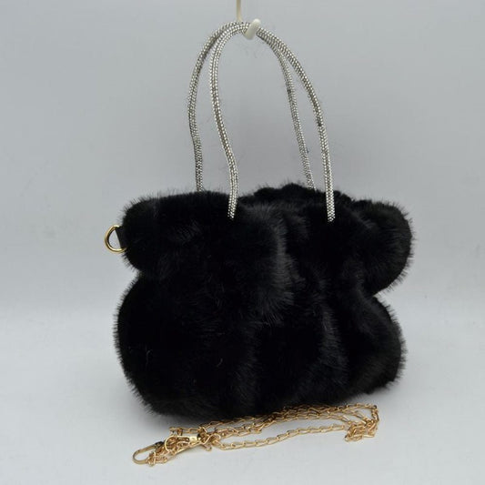 Black This unique everyday handbag features a soft, dense plush exterior that brings a cozy texture and modern look to your accessory collection. Designed with a slouchy, gathered silhouette, it features a central main storage compartment to keep your daily items within easy reach. The bag stands out with dual top handles covered in shimmering rhinestone details for elegant hand carrying, alongside a detachable metallic chain strap that offers versatile hands-free shoulder wear.