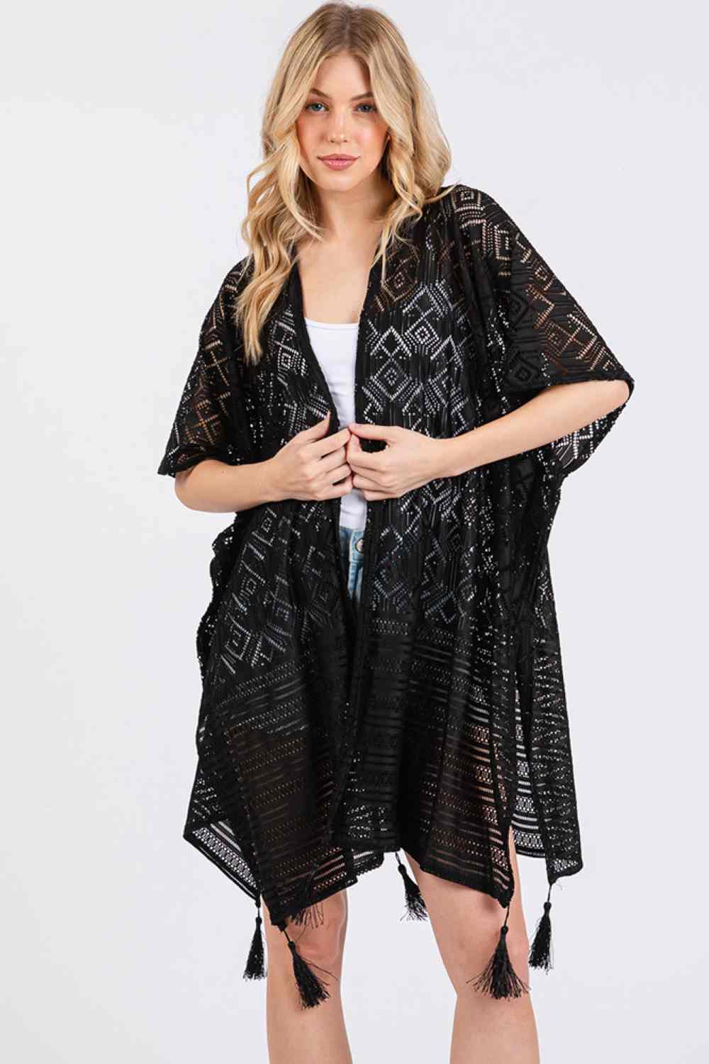 Black Elevate your beach style with this eye-catching geometric pattern cover up. Featuring a vibrant design paired with playful tassels, this lightweight piece is perfect for layering over your swimsuit. The solid construction ensures durability while the breathable polyester fabric keeps you cool and comfortable in the summer heat. Measuring 35" x 33", it offers generous coverage for the pool or beach. An essential addition to any warm-weather wardrobe.
