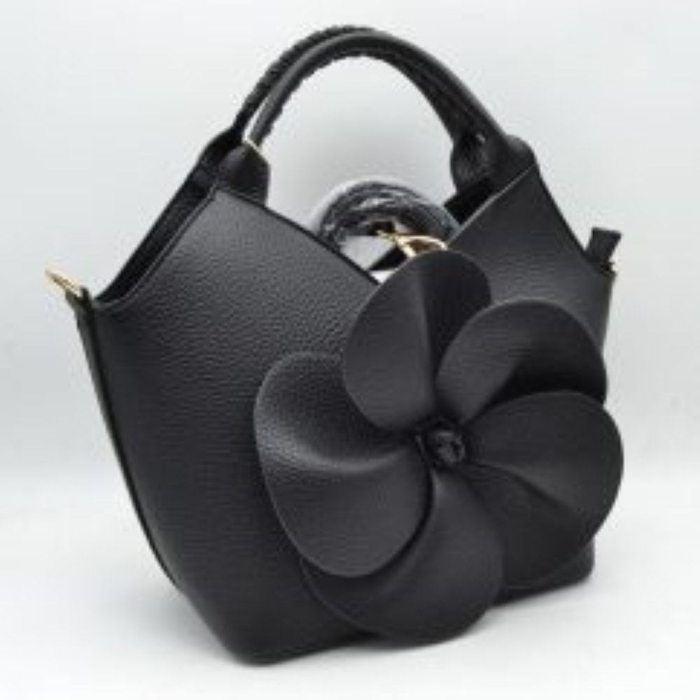 Black Make a whimsical yet sophisticated statement with this gorgeous winged satchel handbag, designed to bring an artistic and romantic flair to your accessory wardrobe. Crafted with a clean, structural silhouette and an elegant flared-wing shape, the front is beautifully adorned with a prominent, sculptural 3D five-petal flower applique that creates stunning dimension and immediate visual appeal. 