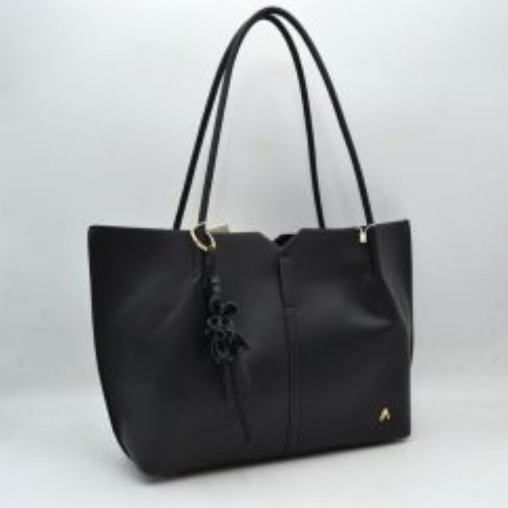 Black Bring a clean, contemporary aesthetic to your daily wardrobe with this sophisticated tote bag. Featuring a distinctive geometric cutout design along the upper trim, this shoulder bag offers a modern architectural edge while remaining perfectly functional. The smooth, textured exterior is detailed with subtle vertical center stitching and a small, polished metallic logo accent on the lower corner. Designed for comfort and convenience