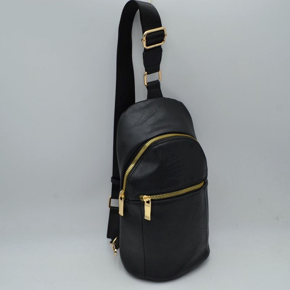 Black This practical sling bag features a textured, grained finish exterior engineered for active everyday use. It provides multiple tiered storage compartments, including a curved main zippered section and a smaller, secondary horizontal zippered front pocket to keep essentials organized. The bag is designed with a single wide shoulder strap style that connects through a square metallic loop and includes an integrated adjustment buckle to alter the carrying length easily.