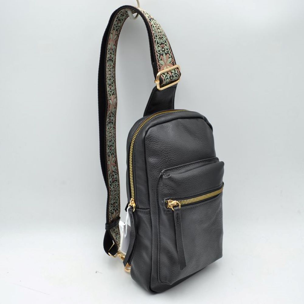 Black This functional sling bag features a contoured silhouette designed for comfortable everyday use and hands-free convenience. It offers structured storage compartments, including a main zippered section and a front zippered pocket equipped with extended pull tabs. The wide, adjustable shoulder strap showcases an intricate embroidered geometric pattern and features a metallic slide buckle for a customizable fit across the body, attaching securely with durable metal hardware.