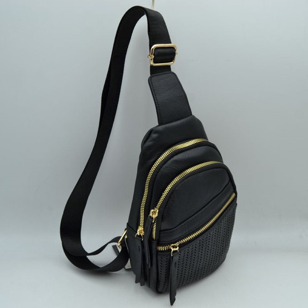 Black This functional sling bag features a textured, grained finish with a multi-tiered silhouette engineered for organized everyday use. It provides multiple distinct storage compartments, including a primary curved main section, an intermediate arched pouch, and a lower pocket featuring a horizontal zipper closure and a decorative perforated design. The bag is completed by a single wide.