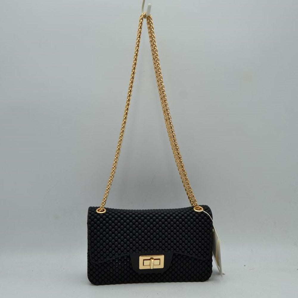 Black This rectangular flap bag showcases a distinctive all-over bumpy textured design that adds unique tactile interest, making it a stylish choice for everyday use. The main storage compartment is safely secured by a front flap featuring a metallic twist-lock closure. Designed for easy carrying, the bag incorporates a long metallic chain shoulder strap fed through top eyelets, allowing it to rest comfortably on the shoulder throughout the day.