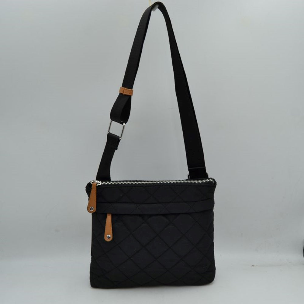 Black This functional messenger bag presents a classic diamond-quilted pattern across its main body, making it a reliable option for organized everyday use. It features a secure top zipper closure that opens to the primary storage compartment, complemented by a secondary horizontal zippered pocket on the front panel for quick-access items. Distinctive contrast tabs with metallic studs detail the zipper pulls