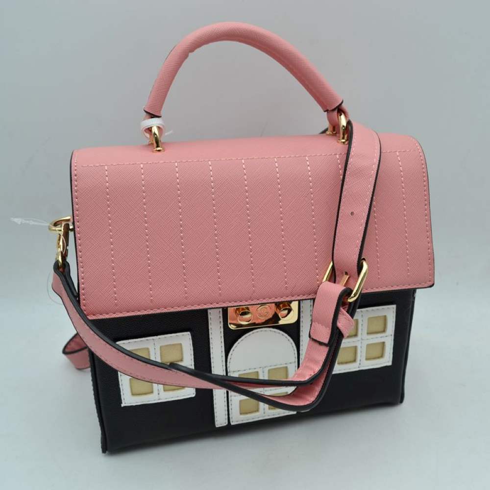 Black Showcase your playful sense of style with this charming novelty house-shaped satchel bag, a whimsical conversational piece that adds an instant pop of personality to any look. Designed to mimic a classic cottage, this structural handbag features a contrast-stitched top flap resembling a tiled roof, paired with a detailed facade complete with cutout windows and a central doorway. The bag is securely fastened with a gleaming metallic latch that blends seamlessly into the design.