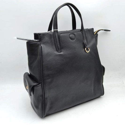 Black This everyday tote bag features structured dual top handles for hand or forearm carrying, paired with a secure top zipper closure that extends slightly beyond the edge. The front panel is detailed with a covered central button accent and a small metallic ring attached near the base of one handle. Designed for convenient organization, the exterior includes functional side pockets with buttoned flaps, while the main compartment offers ample storage space for daily essentials.