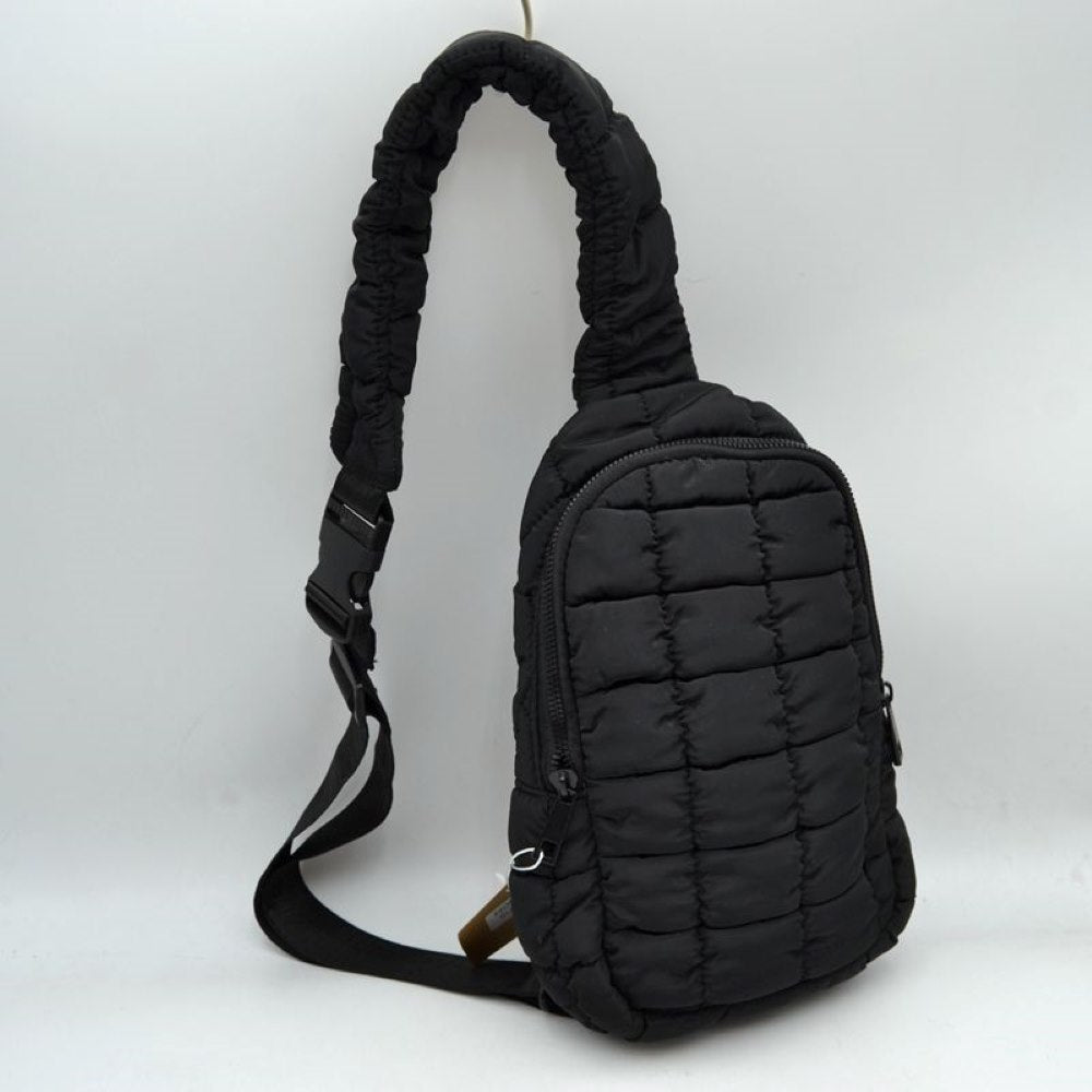 Black Stay effortlessly hands-free with the ultra-trendy sling bag. Combining an ergonomic, close-to-body fit with the highly sought-after puffer aesthetic, this compact pack is the ultimate accessory for city commuting, travel, hiking, or casual day trips.