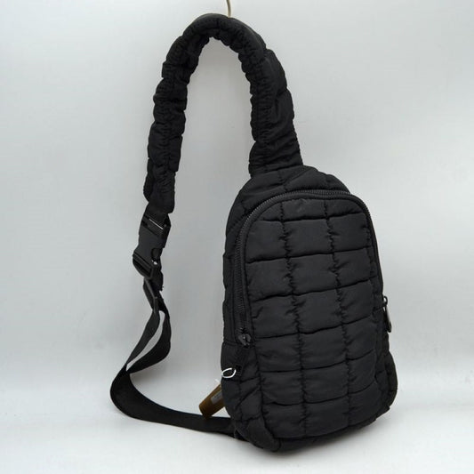Black Stay effortlessly hands-free with the ultra-trendy sling bag. Combining an ergonomic, close-to-body fit with the highly sought-after puffer aesthetic, this compact pack is the ultimate accessory for city commuting, travel, hiking, or casual day trips.