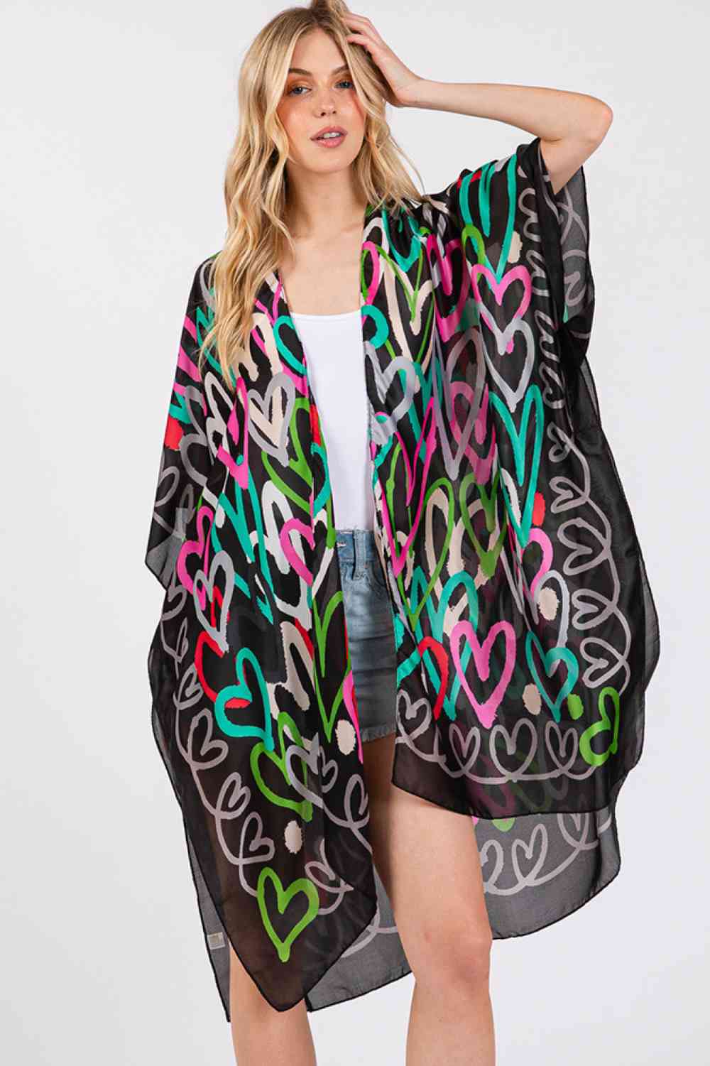 Black Add a touch of romance to your summer collection with this multi-colored heart pattern kimono cover-up. Constructed from 100% polyester with a luxuriously silky feel, it's designed for comfort and style during warm months. The 35" x 36" dimensions offer generous coverage perfect for layering over swimwear or lightweight dresses. This versatile piece transitions seamlessly from beach days to casual evening wear, with a soft fabric that resists fading and maintains its silky texture through regular wear