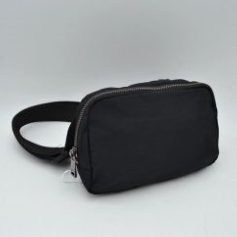 Black This minimalist bag features a smooth, clean design ideal for versatile everyday use. The main storage compartment is secured by a curved top zipper with dual pulls for easy access to essentials. A wide, adjustable strap extends from the sides, complete with a matching slider to easily customize the fit for comfortable carrying.