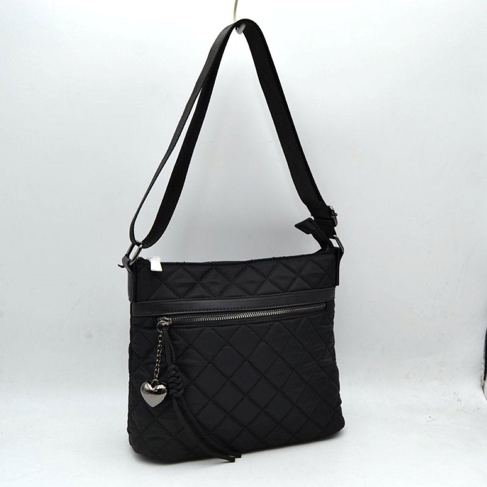 Black This casual crossbody bag features a classic quilted diamond pattern and a slim, flexible profile tailored for everyday use. It provides functional storage compartments, including a secure top zipper closure for the main area and a prominent horizontal zippered front pocket for easy access to smaller essentials. A decorative heart-shaped metallic charm paired with a knotted fabric accent extends from the front zipper pull