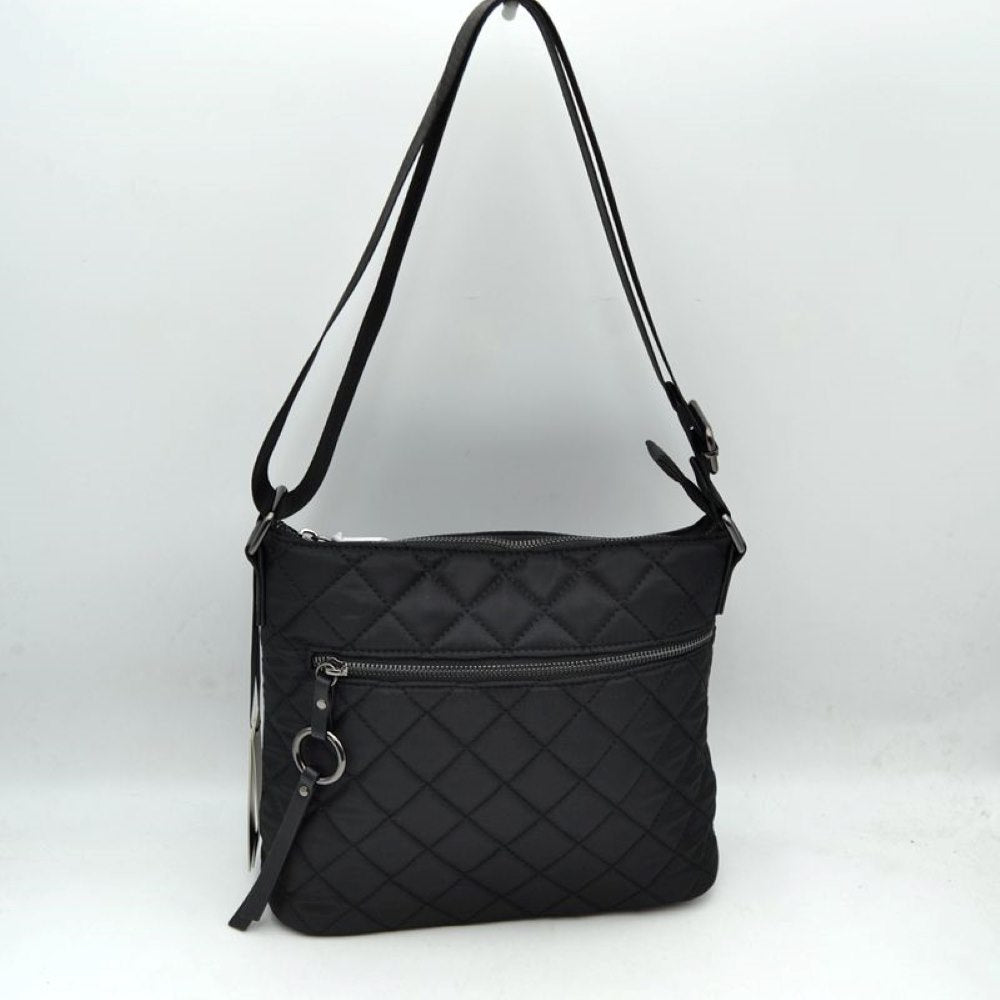 Black This functional crossbody bag features a classic quilted diamond pattern exterior designed for effortless everyday use. It offers multiple storage compartments, including a main interior section accessed by a top zipper closure and a horizontal front zippered pocket accented by an attached circular ring pull tab. The bag is equipped with a matching flat shoulder strap connected by side loops, featuring an integrated adjustment buckle to easily customize the carrying length.