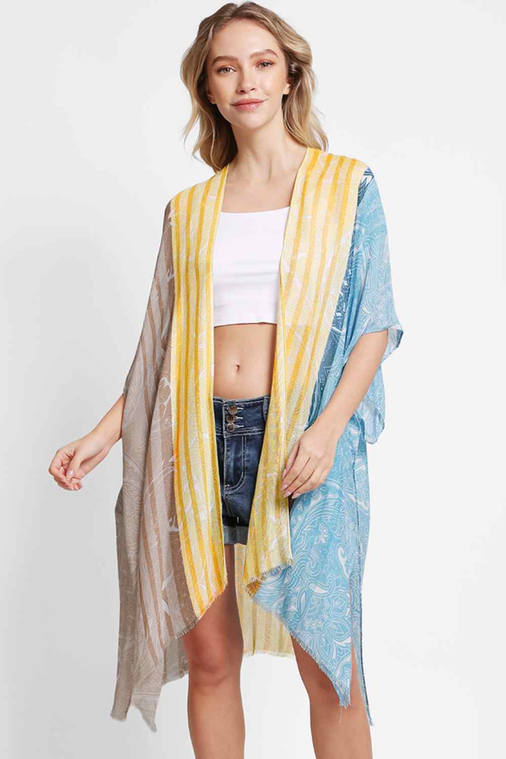 Black Effortless elegance meets summer style with this Paisley Pattern Stripe Kimono Cover Up. Crafted from 100% viscose, the lightweight fabric drapes beautifully while keeping you cool and comfortable. The intricate paisley and stripe design adds visual interest to any beach or resort look. Perfect for layering over swimwear or wearing as a standalone piece. Dimensions: 38" x 39". Made in China.