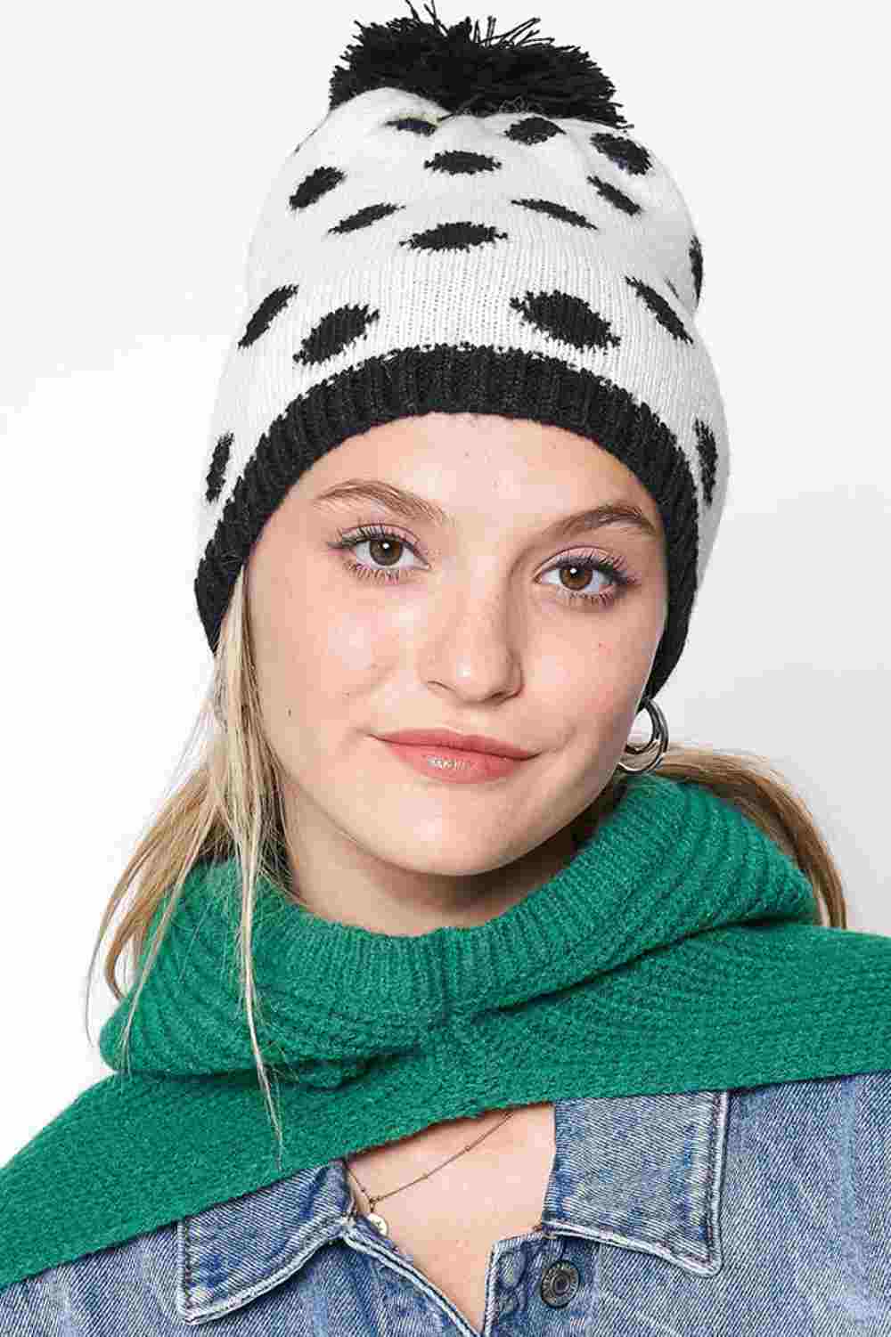 Black Polka Dot Christmas Holiday Theme Pom Beanie features festive polka-dot detailing topped with a fluffy pom for a cheerful seasonal look. Made with a soft stretch fit, it keeps you warm and cozy while adding playful holiday charm to your winter outfits.