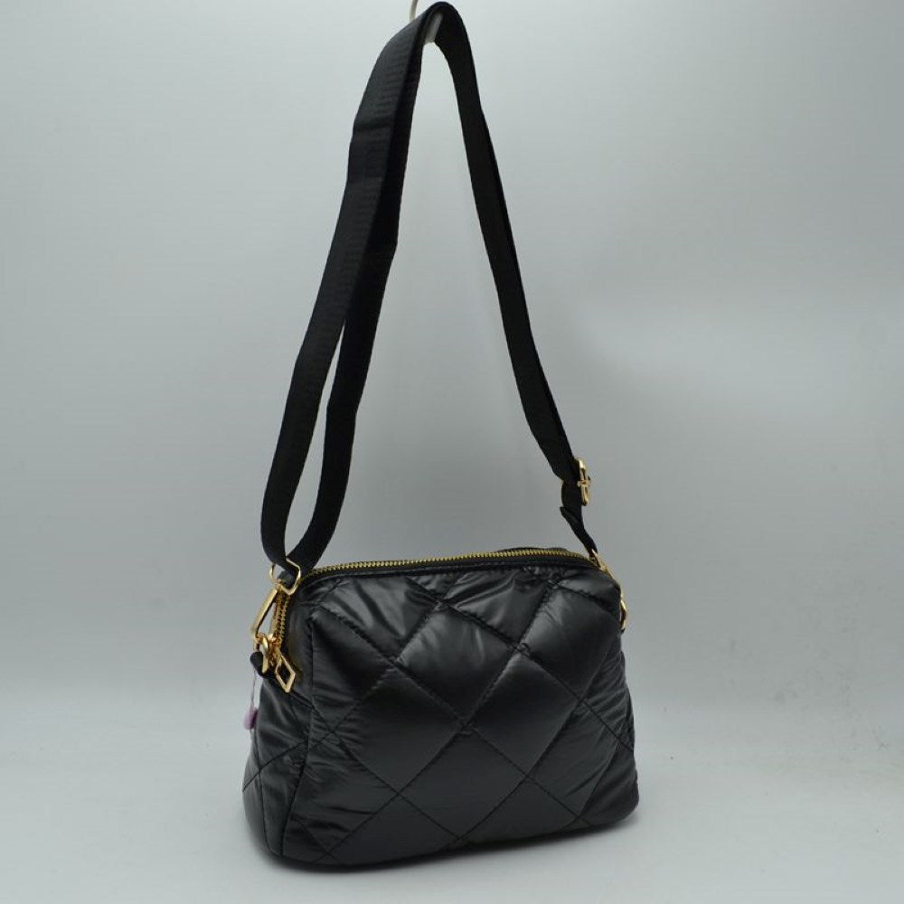Black Upgrade your daily look with our Quilted Puffer Crossbody Bag. Blending street-style athleisure with everyday luxury, this handbag is engineered to keep your essentials organized without adding heavy bulk to your shoulders.
