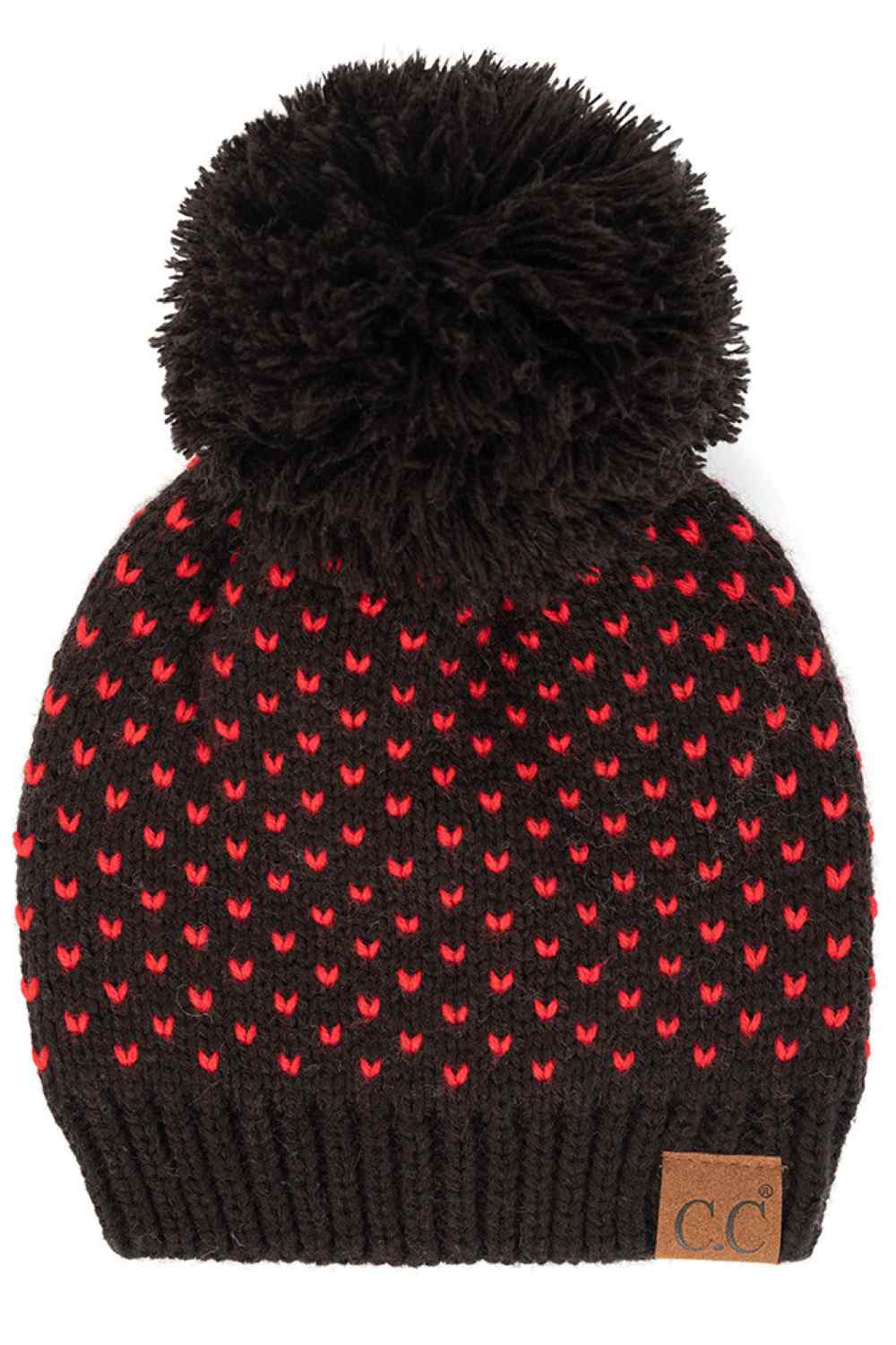 Black Red The C.C Heart Pattern Knit Pom Beanie features a charming heart design that adds a playful touch to your winter wardrobe. Crafted from soft, stretchy knit fabric with a cozy pom accent, it delivers warmth, comfort, and effortless seasonal style.