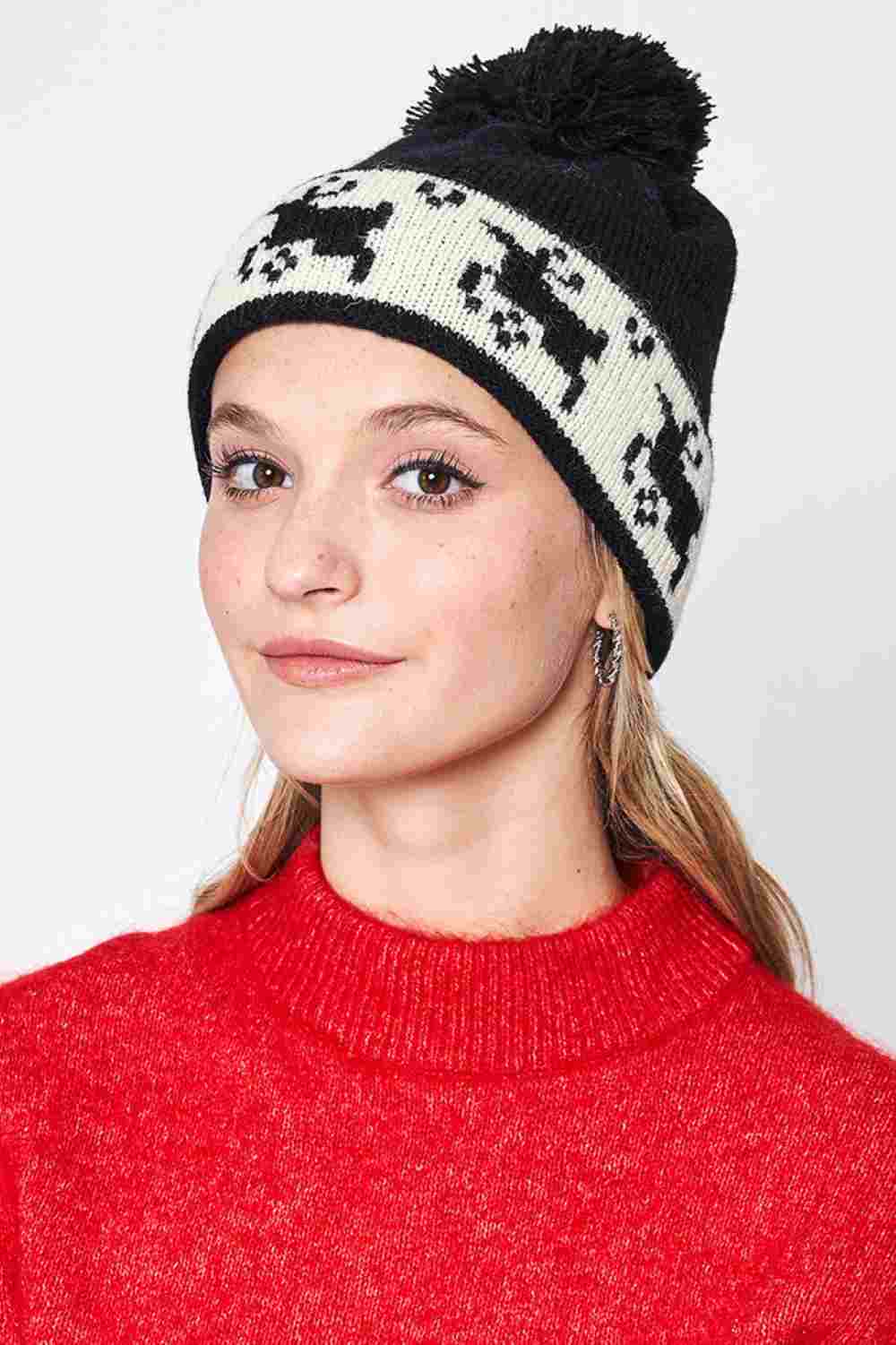 Black Reindeer Christmas Holiday Pom Beanie features festive reindeer detailing topped with a fluffy pom for a cheerful, winter-ready holiday look. Designed with a soft stretch fit, it keeps you warm and cozy while adding playful seasonal charm to your cold-weather outfits.