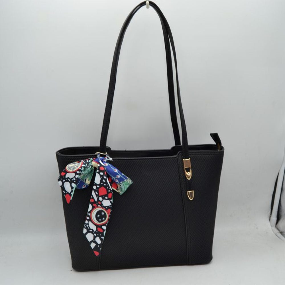 Black Bring a touch of effortless resort-chic into your daily routine with this stunning cream and cognac shoulder tote. Designed with an elegant chevron-textured weave and beautifully contrasted by rich, warm tan accents, this bag is the ultimate fusion of classic sophistication and everyday practicality. Perfect for office styling, weekend getaways, or casual city strolls, it arrives detailed with a colorful, artistic silk-style scarf playfully tied to the handle for an immediate touch of luxury.