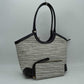 Black Infuse your daily routine with classic sophistication with this elegant two-piece handbag set, featuring a spacious shoulder tote and a matching zip-around wristlet wallet. The tote showcases a beautiful multi-tonal woven tweed pattern, sharply contrasted by clean, structured top borders and reinforced base corners that preserve its graceful shape. Designed with extra-long, arched shoulder straps that slip comfortably over your arm