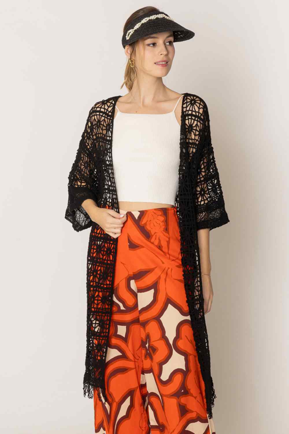 Black Effortless elegance meets comfort in this timeless crochet cardigan. Crafted from 100% cotton, it features an open-weave design that's breathable and perfect for layering. The relaxed fit measures 44" in length with a 20.5" width, offering a flattering silhouette for various body types. Ideal for casual days or dressed-up occasions, this versatile piece transitions seamlessly from season to season. A wardrobe staple that combines style with everyday wearability.