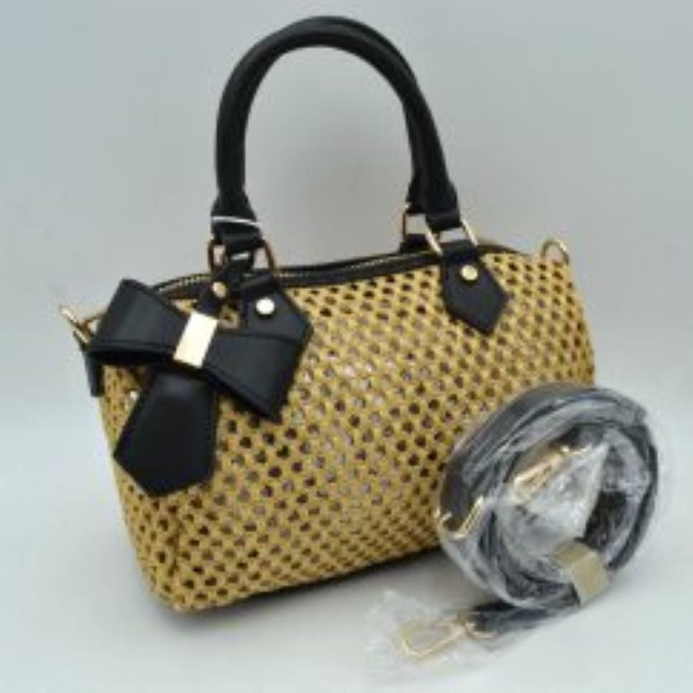 Black This structured satchel handbag showcases an intricate open-weave pattern across its main body, providing a highly textured look suitable for everyday use. It features dual rounded top handles anchored by polished metallic loops and studs, alongside an accompanying detachable, adjustable shoulder strap equipped with metallic swivel clasps for versatile carrying options. A prominent decorative bow accent adds a sophisticated detail to the front panel