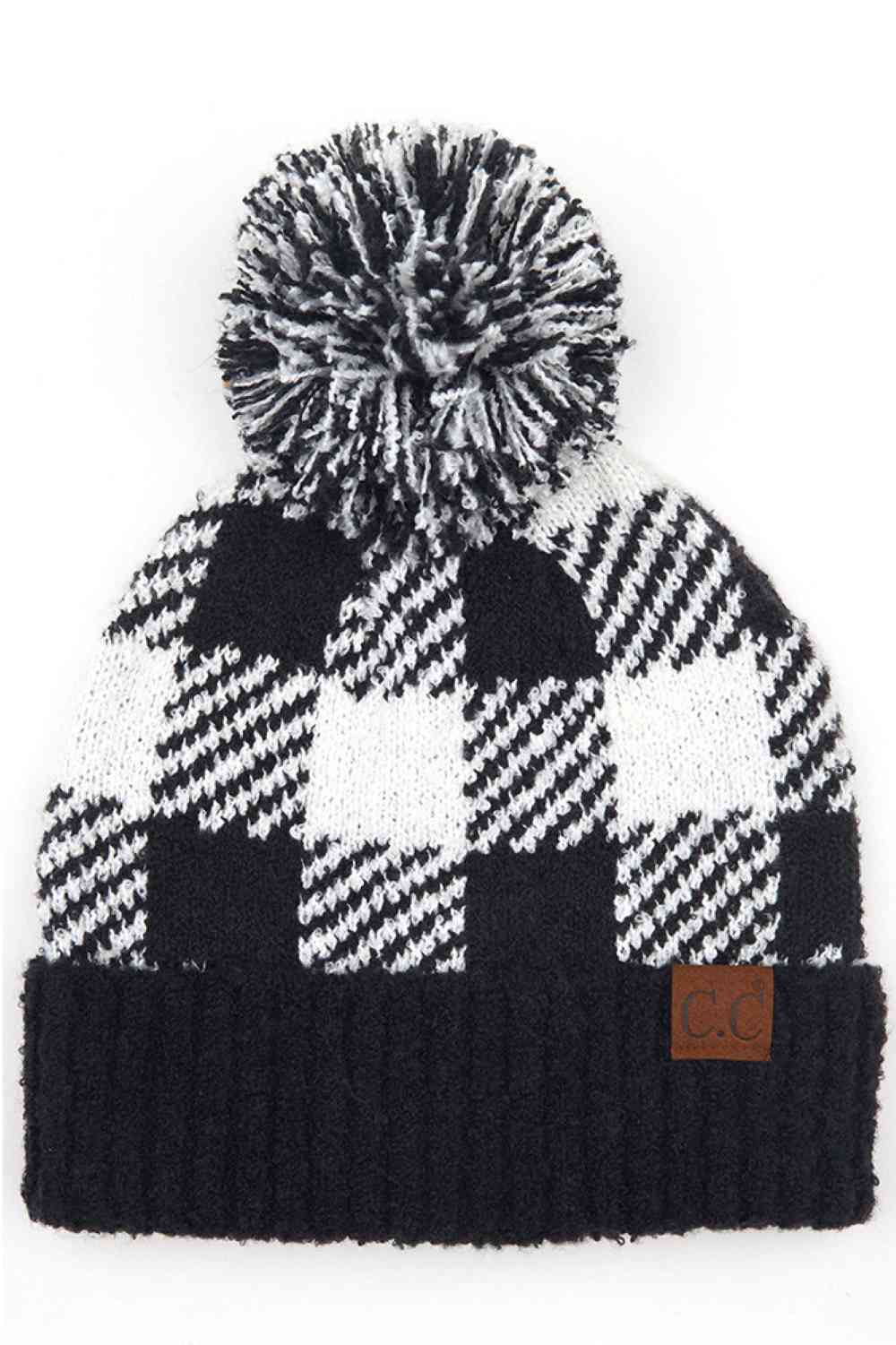 Black White Elevate your winter wardrobe with this C.C Buffalo Check Jacquard beanie featuring a cozy knit pom-pom. The classic buffalo check pattern adds timeless style to any outfit, whether you're heading outdoors or staying in.