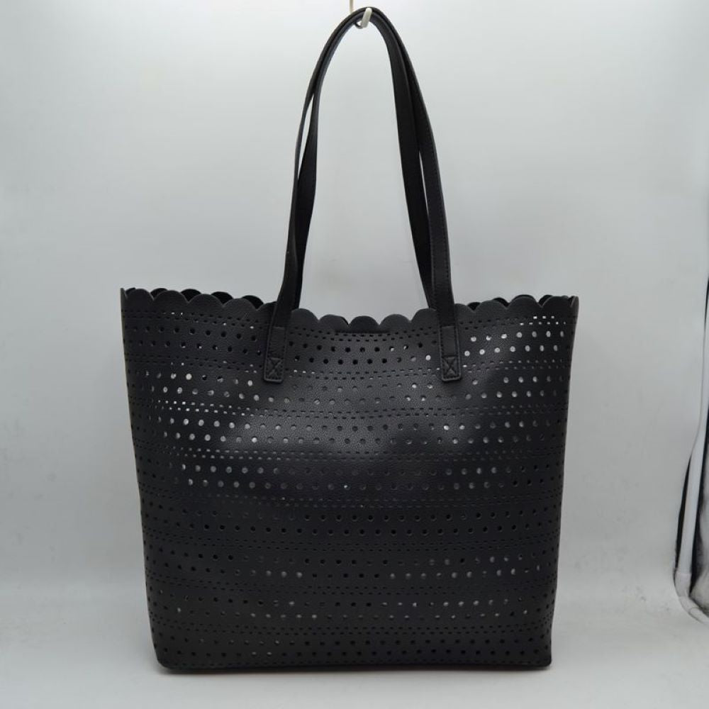 Black Bring an airy, classic look to your everyday style with this elegant perforated tote bag. Featuring an all-over laser-cut geometric pattern arranged in neat horizontal rows, this handbag stands out with its feminine, scalloped top border. The generously sized interior offers plenty of room to hold your daily essentials, electronics, or beach necessities, making it a perfect match for seasonal travel, market runs, or casual daytime outings.