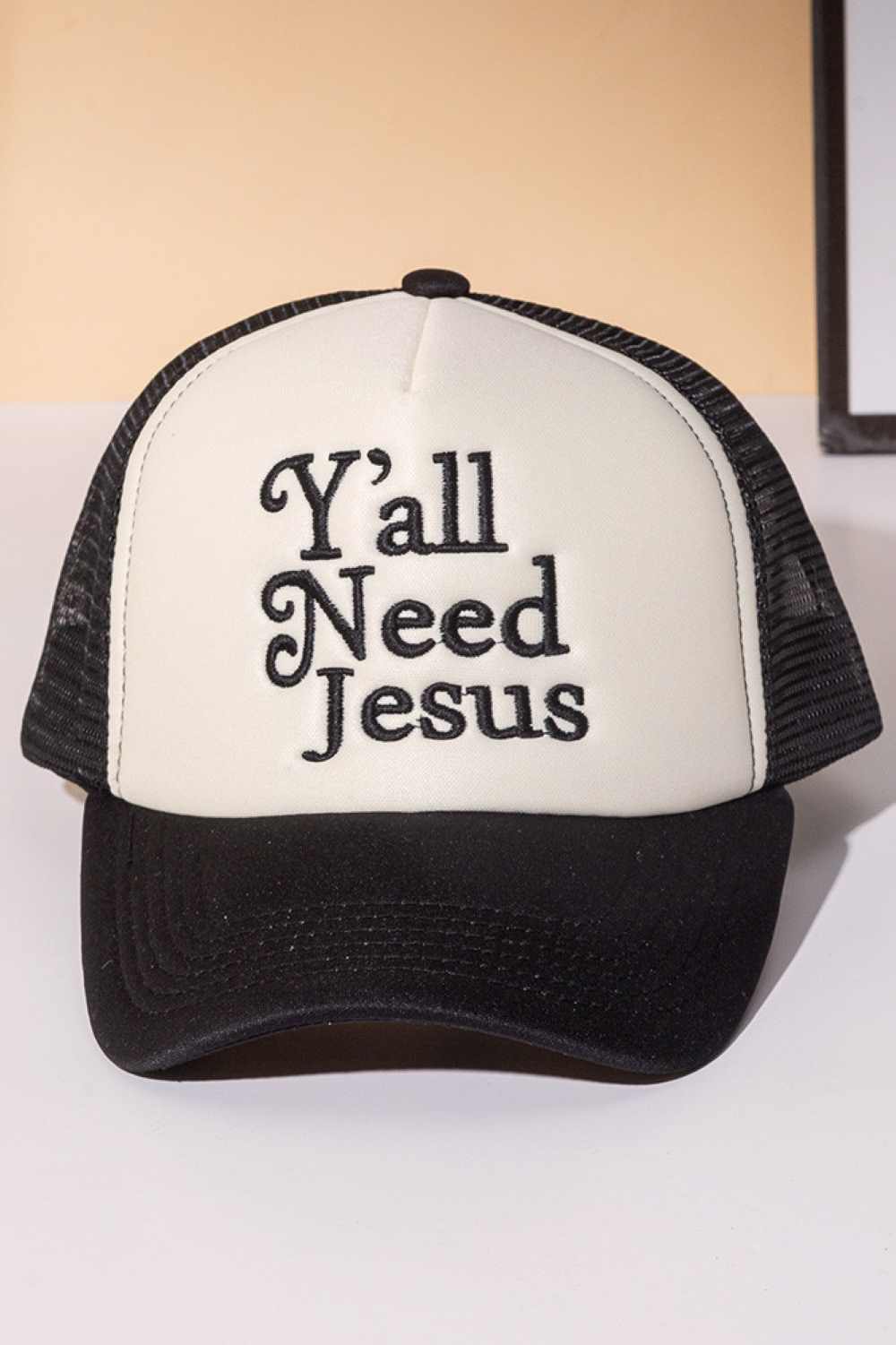 Black Y'ALL NEED JESUS Letter Foam with Mesh Back Trucker Hat Baseball Cap Make a bold statement with this classic trucker cap featuring embroidered lettering across the front. Crafted from 100% polyester with a breathable mesh back panel, it's designed for all-day comfort and ventilation. The structured foam front provides durability and shape retention, while the adjustable snapback closure ensures a perfect fit for most head sizes. Whether you're heading to the gym, running errands, or making a fashion s
